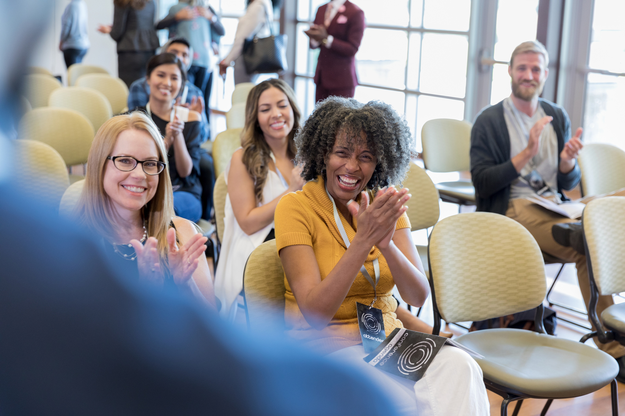 Crowd applauds keynote speaker during conference